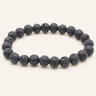 Bracelet en pierre de lave à perles rondes de 8 mm, gris anthracite à noires et poreuses, présenté sur fond beige clair.