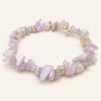 Bracelet baroque en kunzite aux pierres polies rose pâle, lilas, blanchâtres et crème, présenté sur fond beige clair.